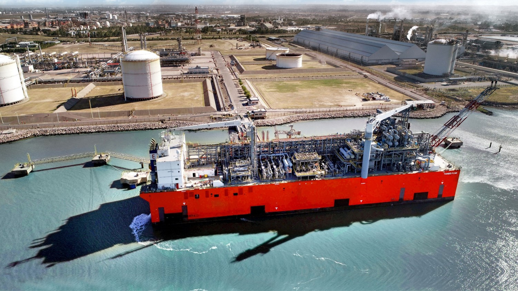 Floating LNG vessel beside an industrial terminal